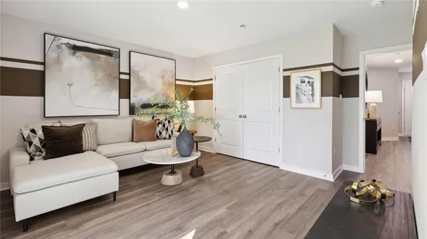a living room with furniture and a wooden floor