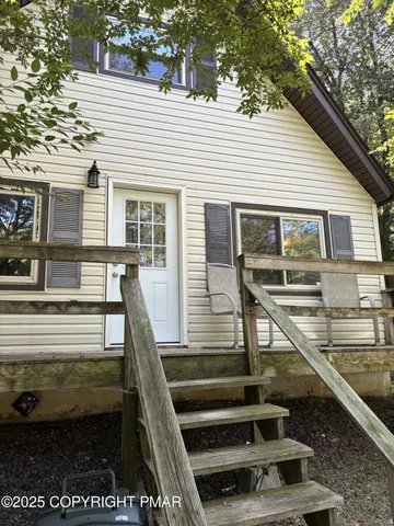 a view of a balcony with two couches and wooden floor