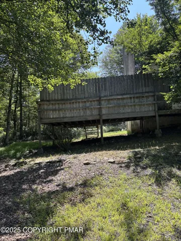 a view of a backyard with wooden fence