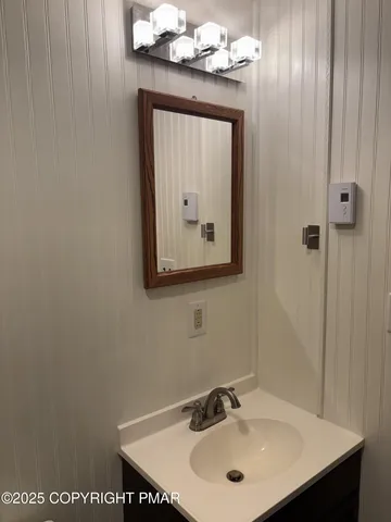 a bathroom with a sink vanity and a mirror
