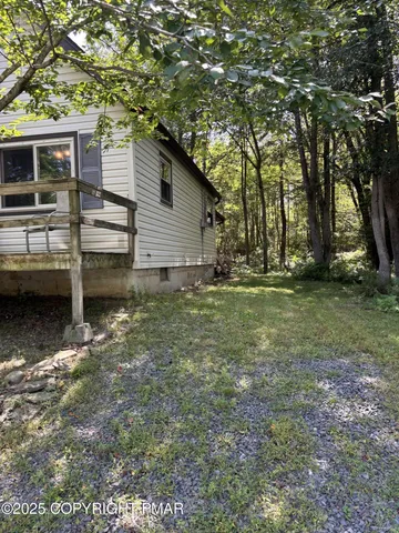 a backyard of a house with barbeque oven