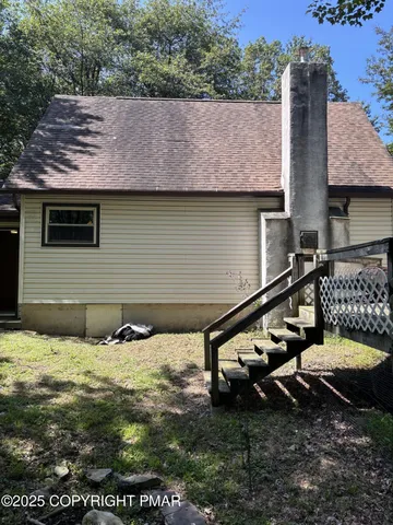 a backyard of a house with yard and outdoor seating