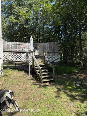 a view of a wooden deck with chairs