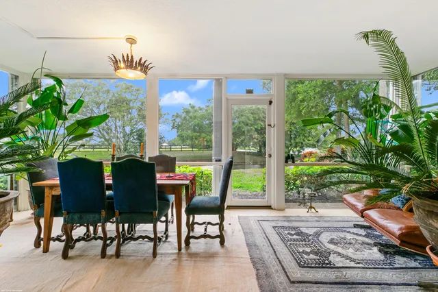 a view of a dining room with furniture window and outside view
