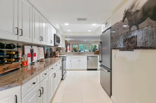 a kitchen with cabinets and window