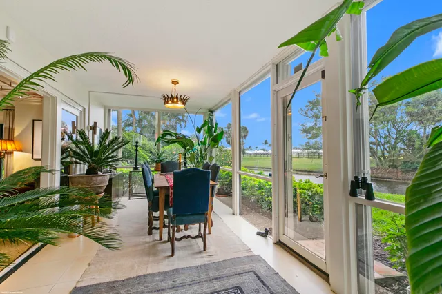 a view of a porch with chairs and potted plants