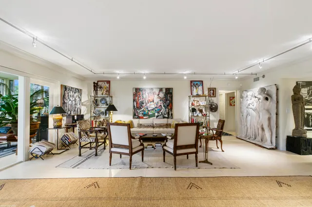 a living room with furniture a window and a flat screen tv