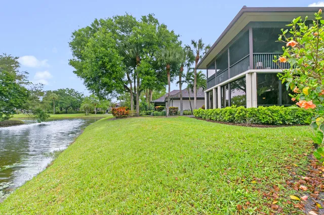 a view of a house with a yard and a garden