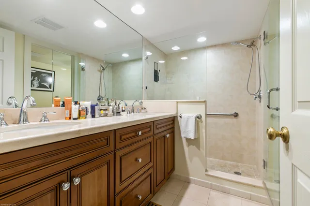 a spacious bathroom with a shower sink and mirror