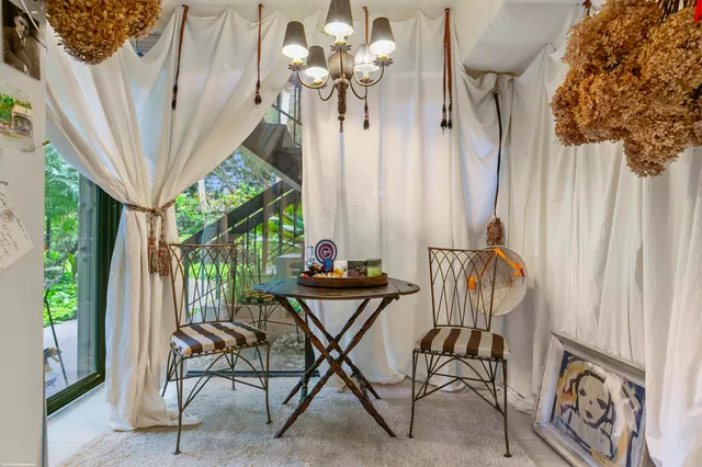 a view of a chairs and table in the balcony
