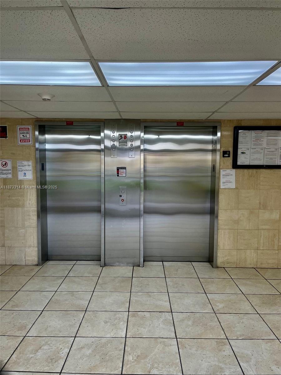 7000 Northwest 186th Street, Unit 4121 Hialeah, FL 33015 - Photo 7 of 27 a room with a wooden bench