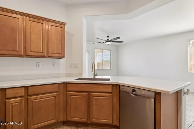 a view of empty room with a window and chandelier