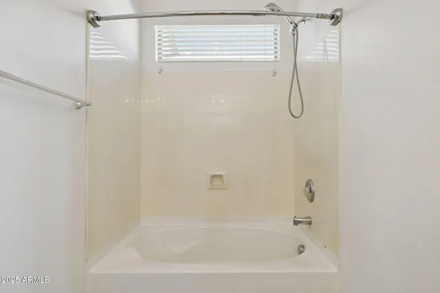 an aerial view of residential houses with outdoor space and lake view