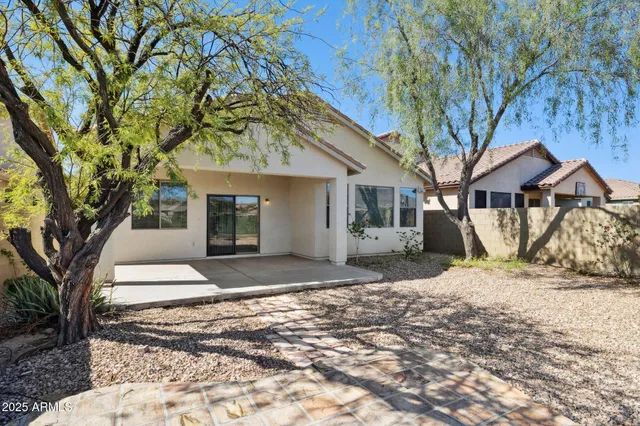 a street sign on a wall next to a road