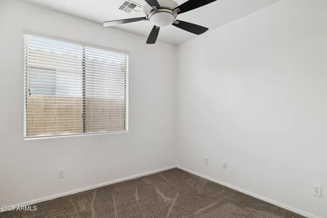 a view of a lake with a table and chairs under an umbrella