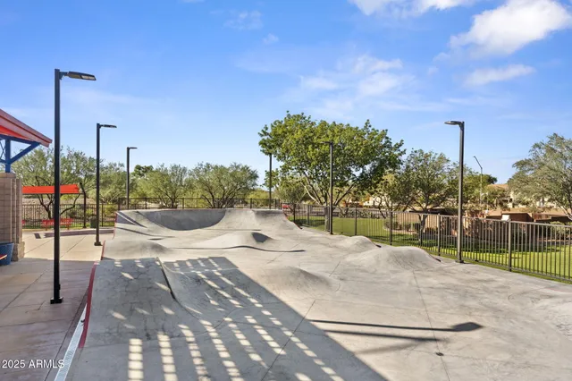 a view of a playground ground and trees