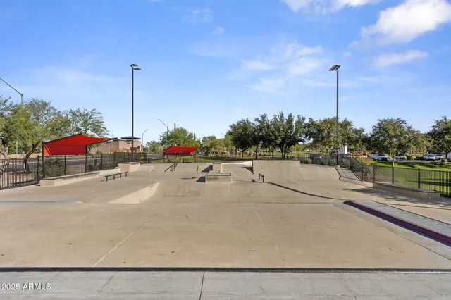 a view of a patio with table and chairs under an umbrella with a large tree