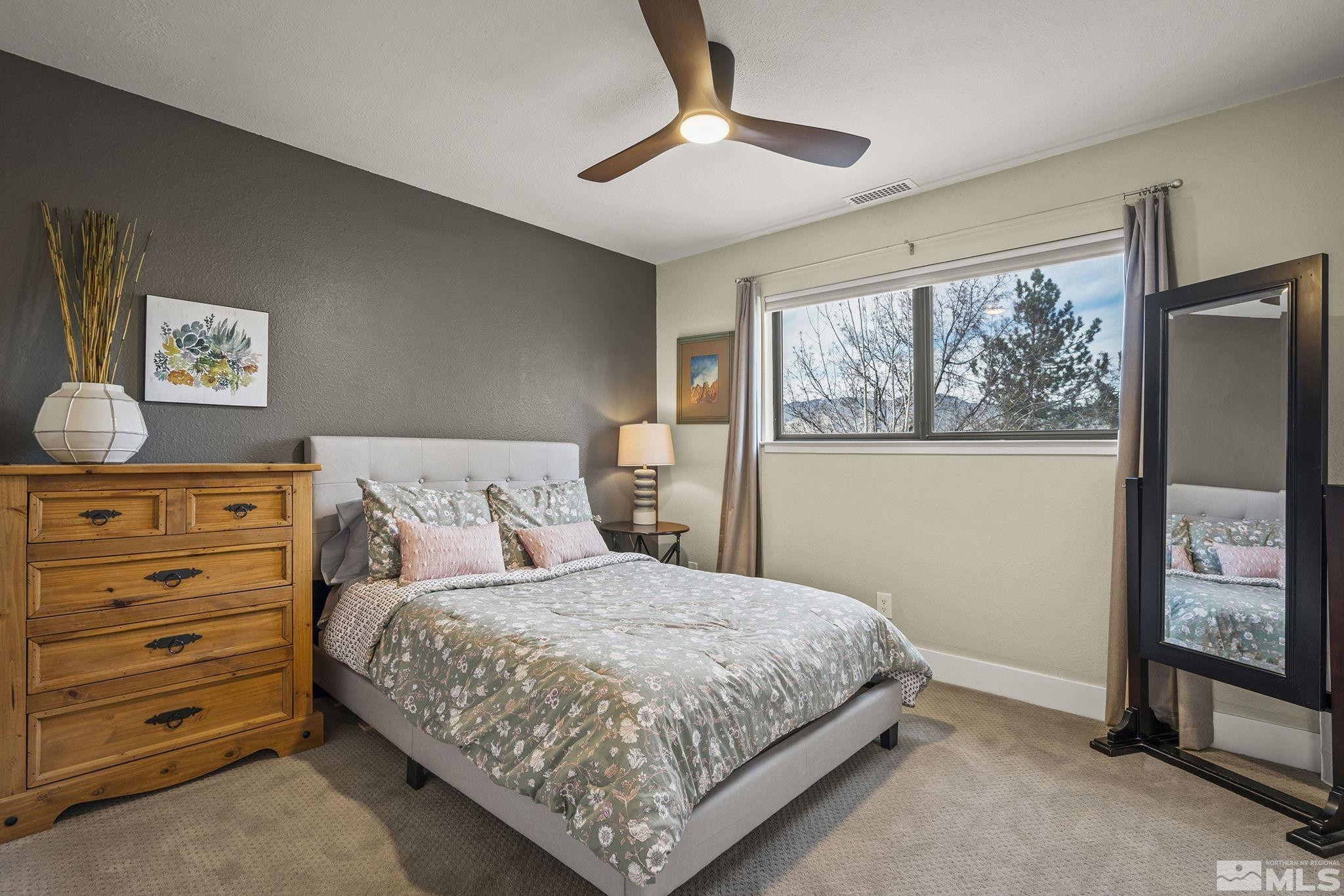 4400 Bridle Way Reno, NV 89519 - Photo 19 of 32 a bedroom with a bed a window and painting on the wall