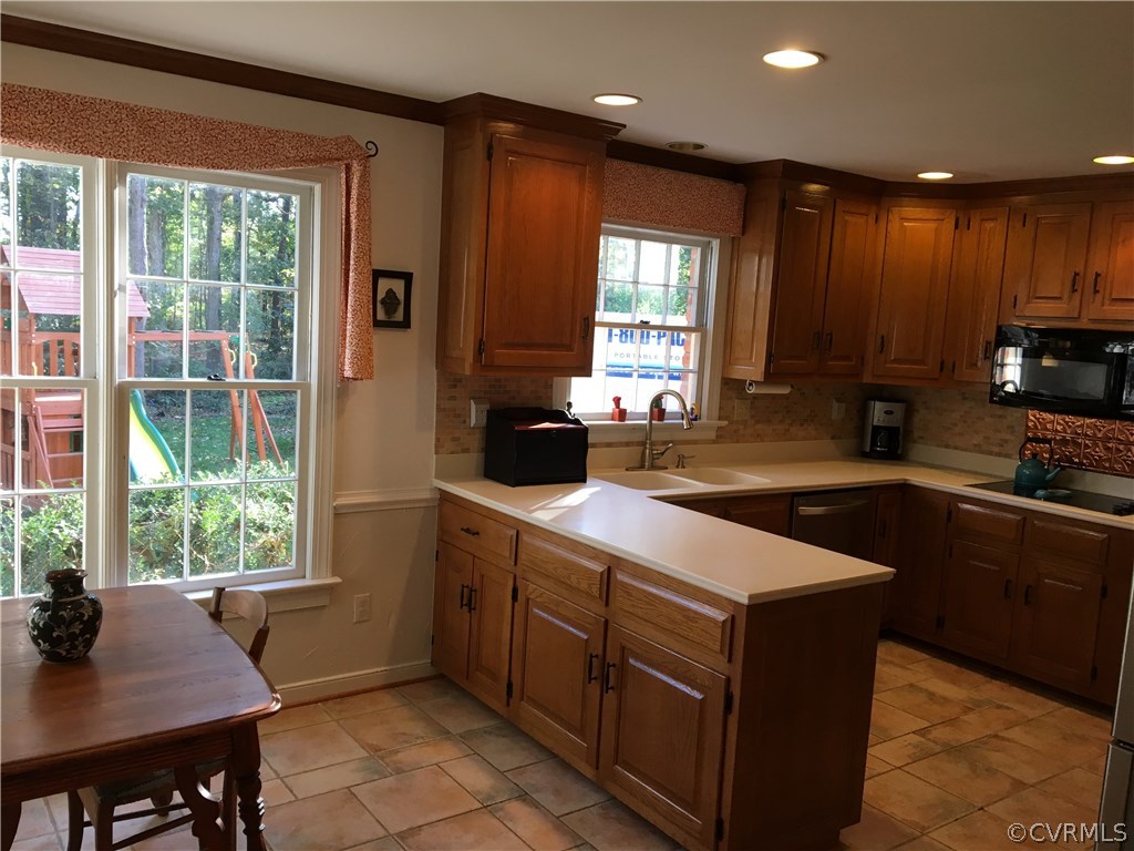 1900 Castlebridge Road Midlothian, VA 23113 - Photo 11 of 28 a kitchen with kitchen island granite countertop a sink counter top space appliances and a window