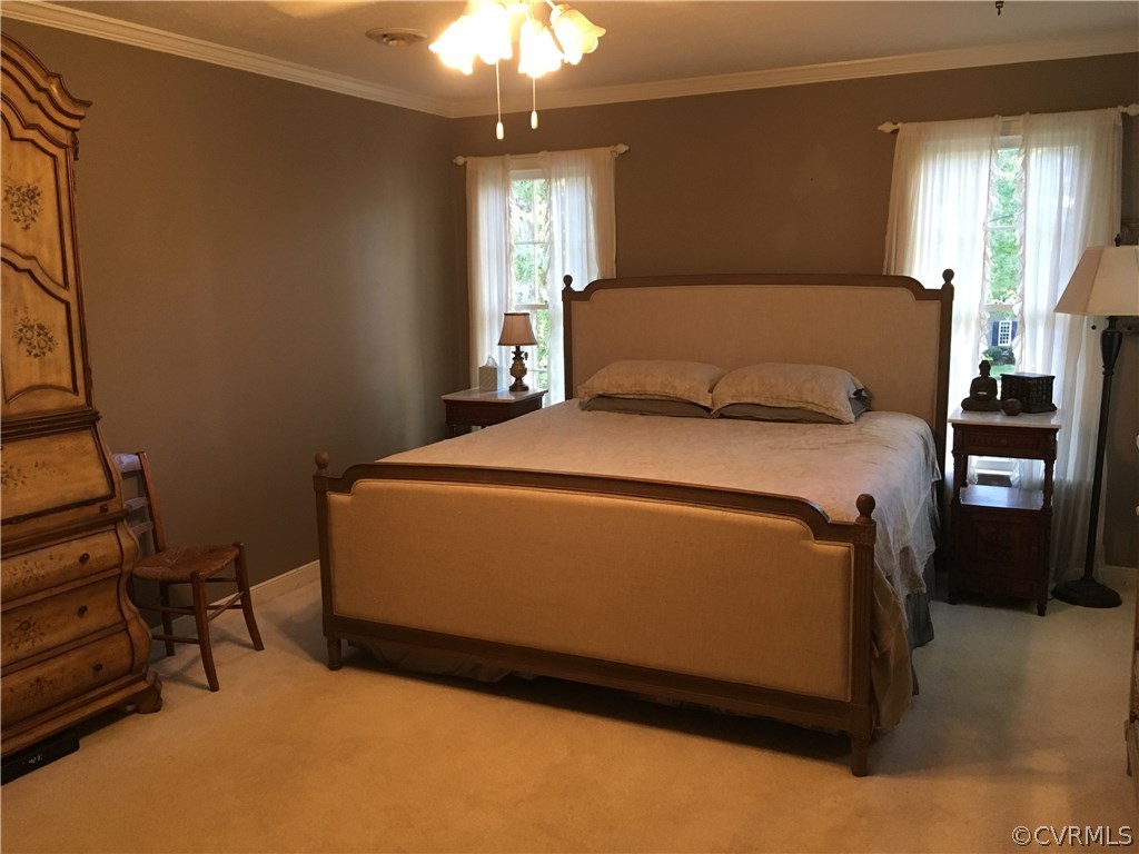 1900 Castlebridge Road Midlothian, VA 23113 - Photo 16 of 28 a bedroom with a bed and a chandelier