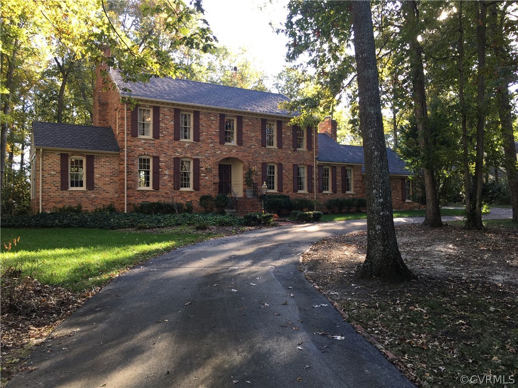 1900 Castlebridge Road Midlothian, VA 23113 - Photo 2 of 28 a front view of a house with a yard street and trees
