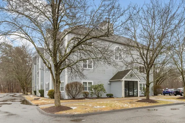 a view of a house with a yard covered in snow