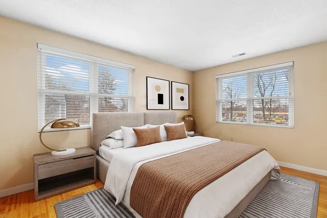 a bedroom with a bed and wooden floor