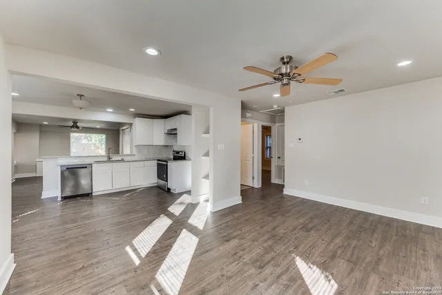 a view of a kitchen with a sink and a refrigerator