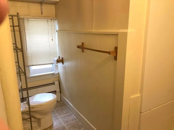 a bathroom with a toilet and a shower