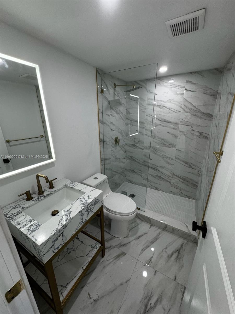 602 Southwest 13th Avenue, Unit 4 Miami, FL 33135 - Photo 10 of 13 a bathroom with a sink toilet and shower