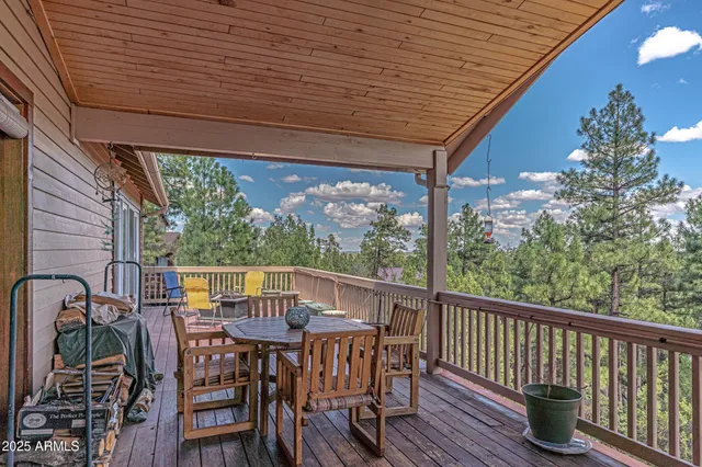 a kitchen with stainless steel appliances granite countertop a stove top oven a sink dishwasher and wooden cabinets with wooden floor