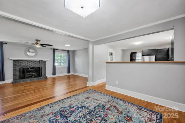 a view of a room with wooden floor and a fireplace
