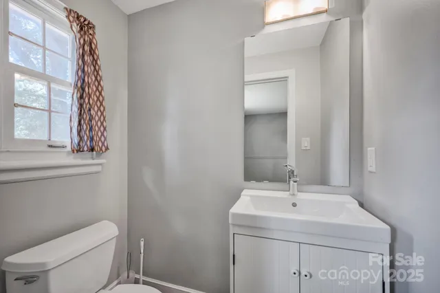 a bathroom with a toilet sink and mirror