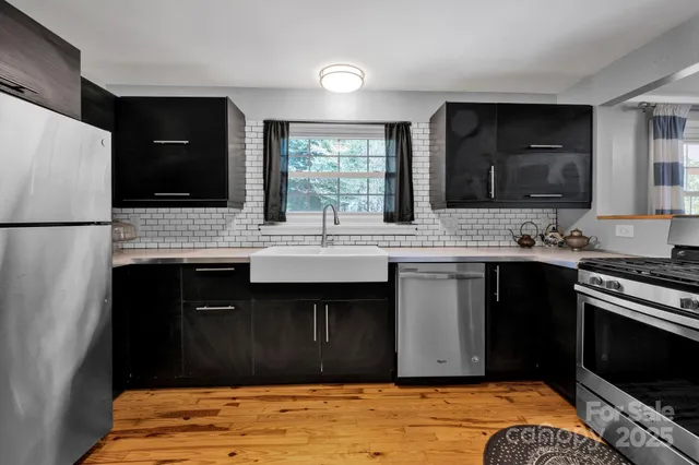 a kitchen with stainless steel appliances granite countertop a stove sink and cabinets