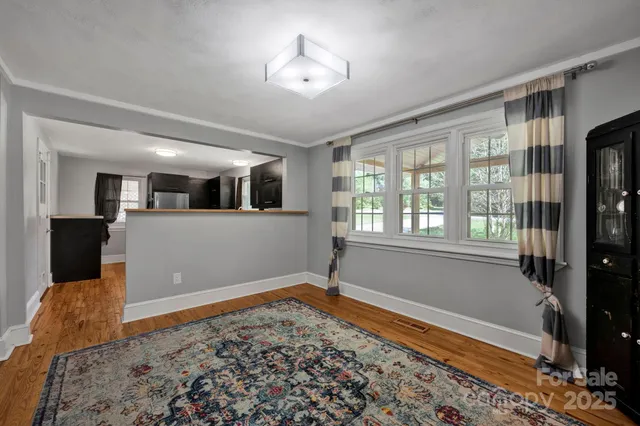 a view of a room with window and hardwood floor