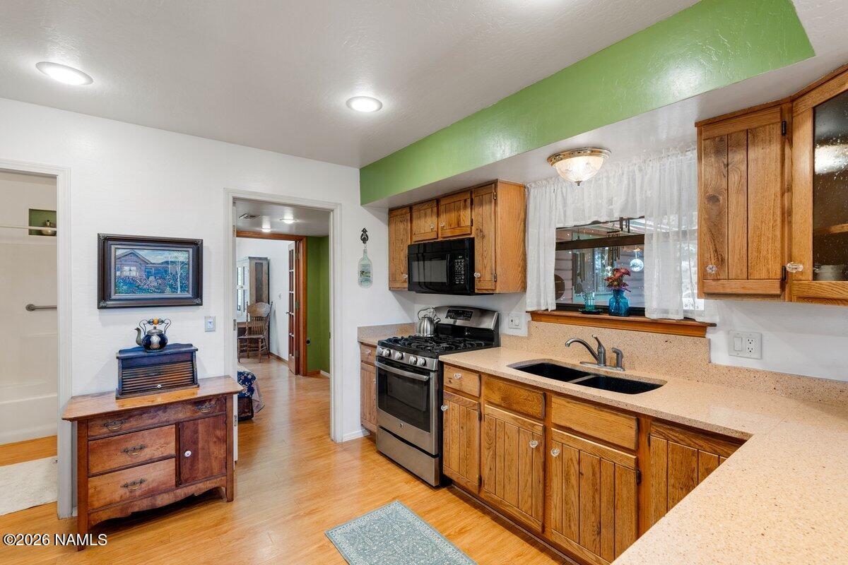 5535 East Western Star Road Flagstaff, AZ 86004 - Photo 11 of 44 a kitchen with stainless steel appliances kitchen island granite countertop a stove and a sink