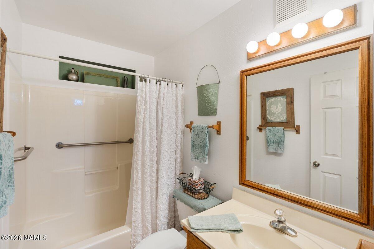 5535 East Western Star Road Flagstaff, AZ 86004 - Photo 14 of 44 a bathroom with a granite countertop sink mirror and shower