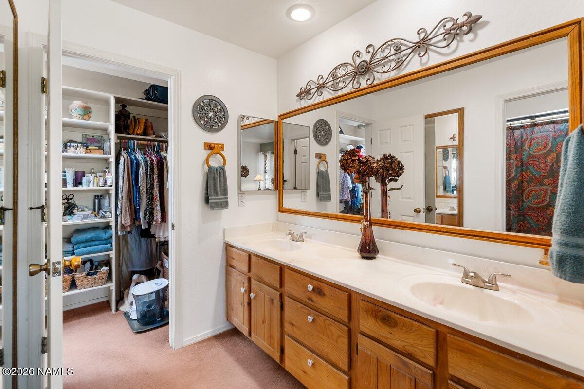 5535 East Western Star Road Flagstaff, AZ 86004 - Photo 24 of 44 a bathroom with a sink double vanity and mirrors