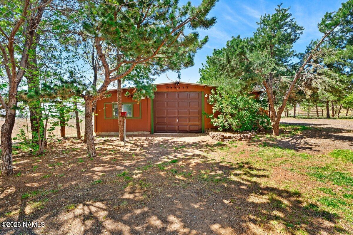 5535 East Western Star Road Flagstaff, AZ 86004 - Photo 29 of 44 a front view of a house with a yard