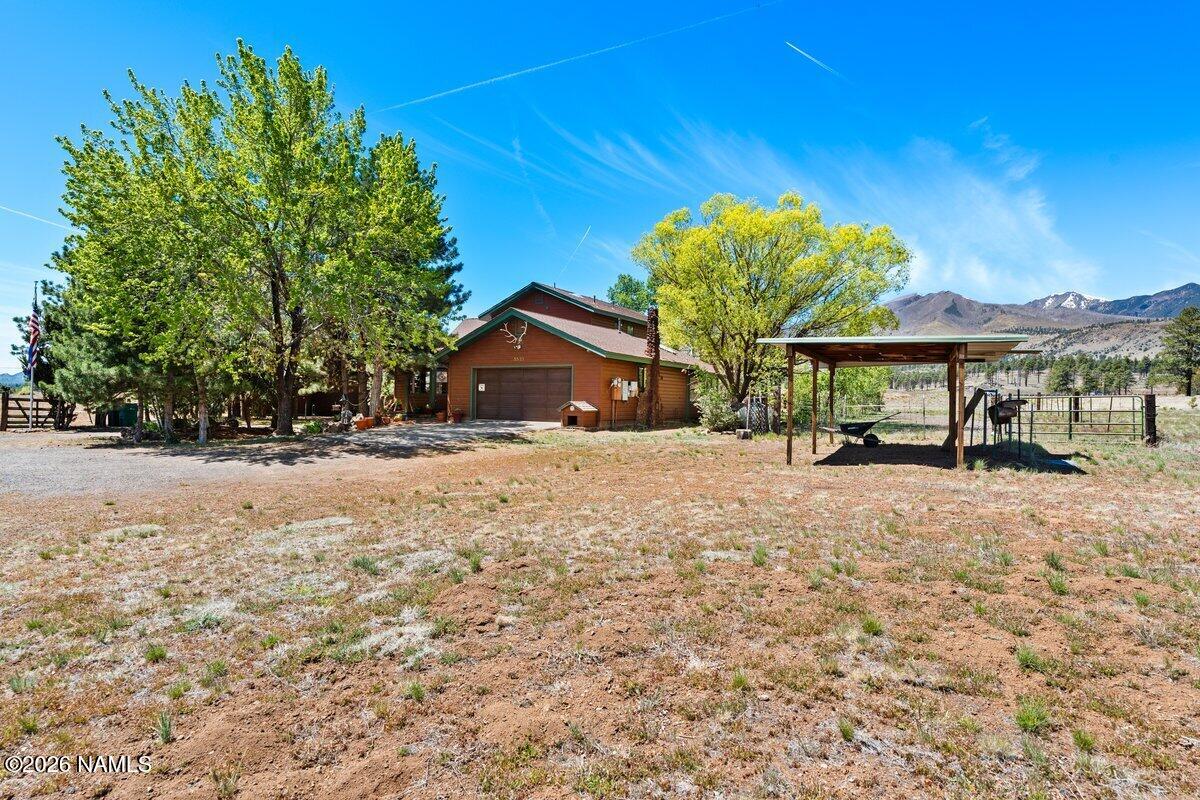 5535 East Western Star Road Flagstaff, AZ 86004 - Photo 39 of 44 a front view of a house with a yard and garage