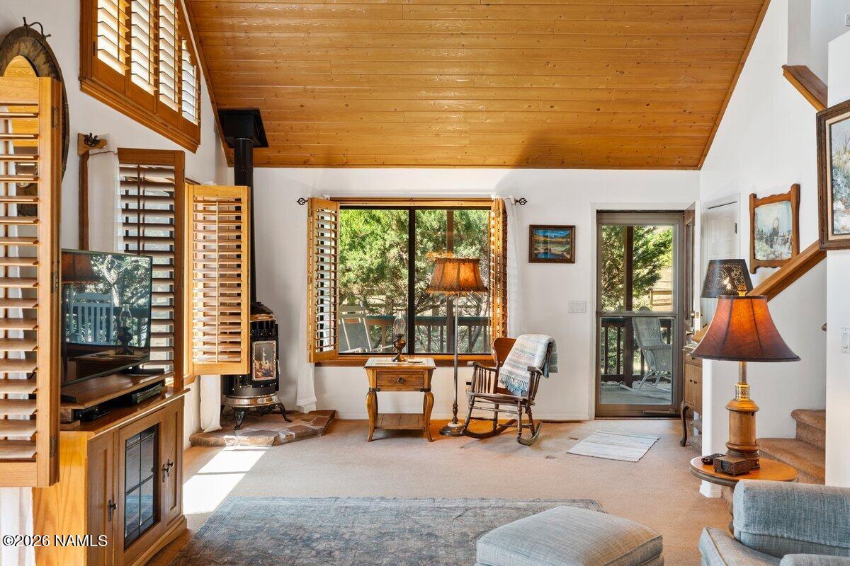 5535 East Western Star Road Flagstaff, AZ 86004 - Photo 4 of 44 a living room with furniture a lamp wooden floor and a large window