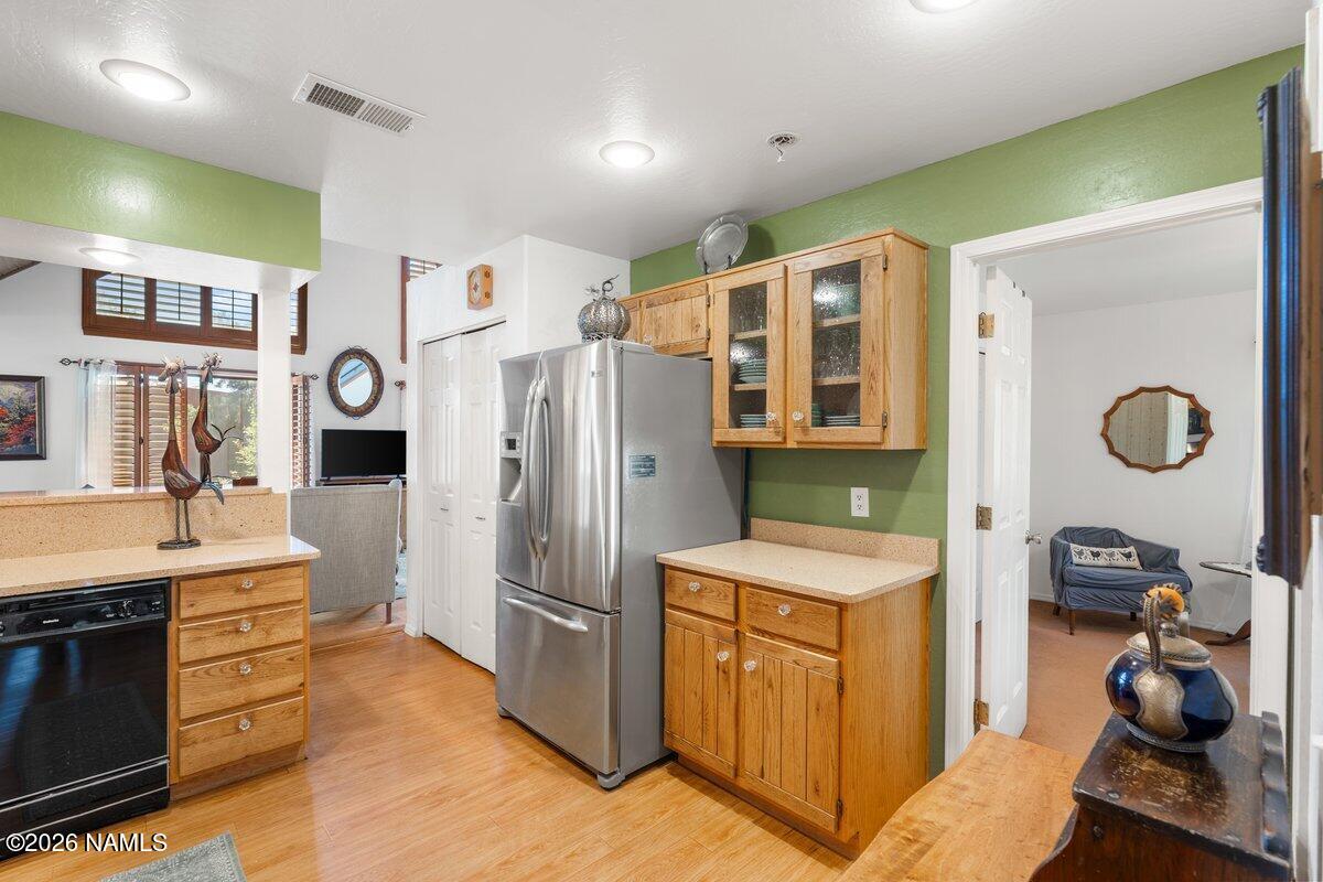 5535 East Western Star Road Flagstaff, AZ 86004 - Photo 9 of 44 a kitchen with stainless steel appliances granite countertop a refrigerator and a stove top oven