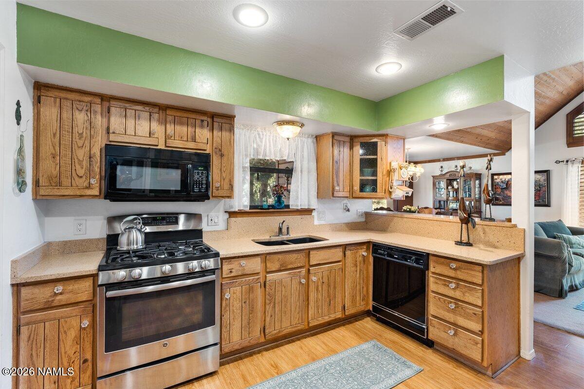 5535 East Western Star Road Flagstaff, AZ 86004 - Photo 10 of 44 a kitchen with a sink stove and microwave