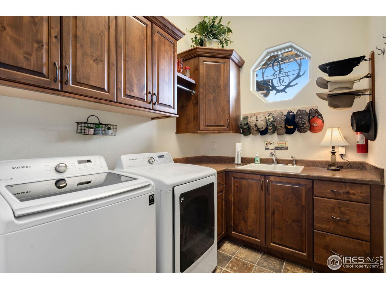 Laundry room on the main with lots of cabinets and a sink