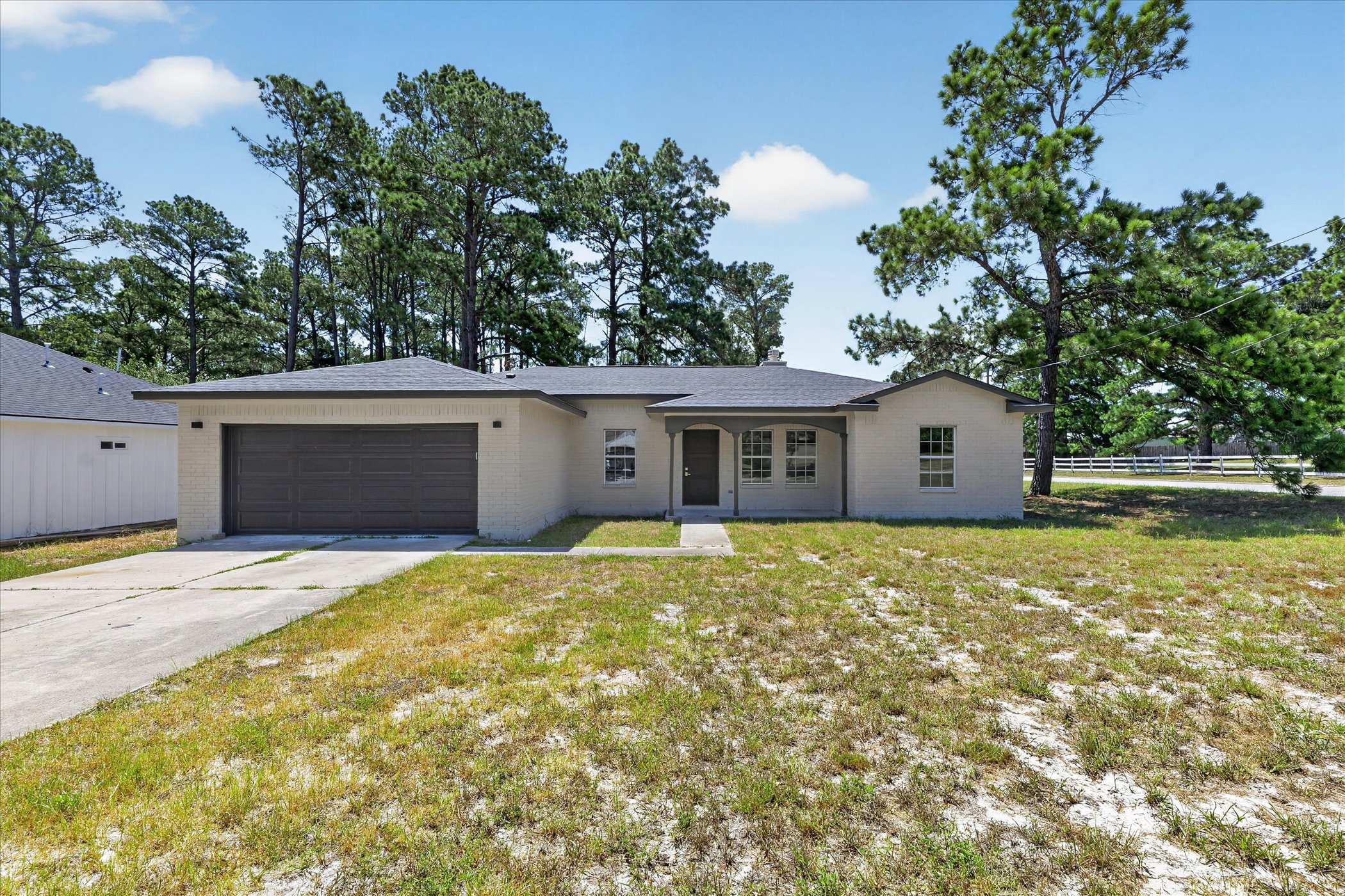258 Pine View Loop Bastrop, TX 78602 - Photo 2 of 40 A classic ranch home features an attached garage and a welcoming front entrance.