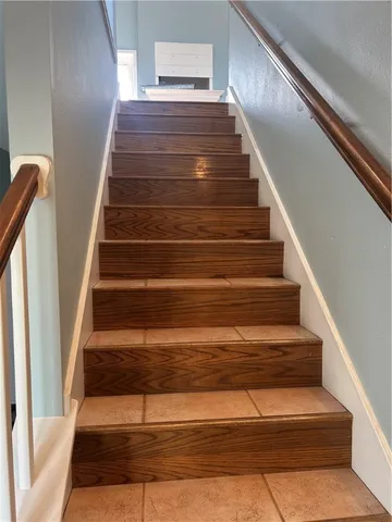 a view of an empty room with a chandelier fan