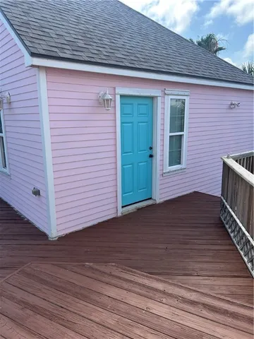 a view of a house with wooden deck