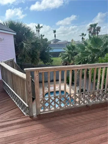 a view of a house with wooden deck