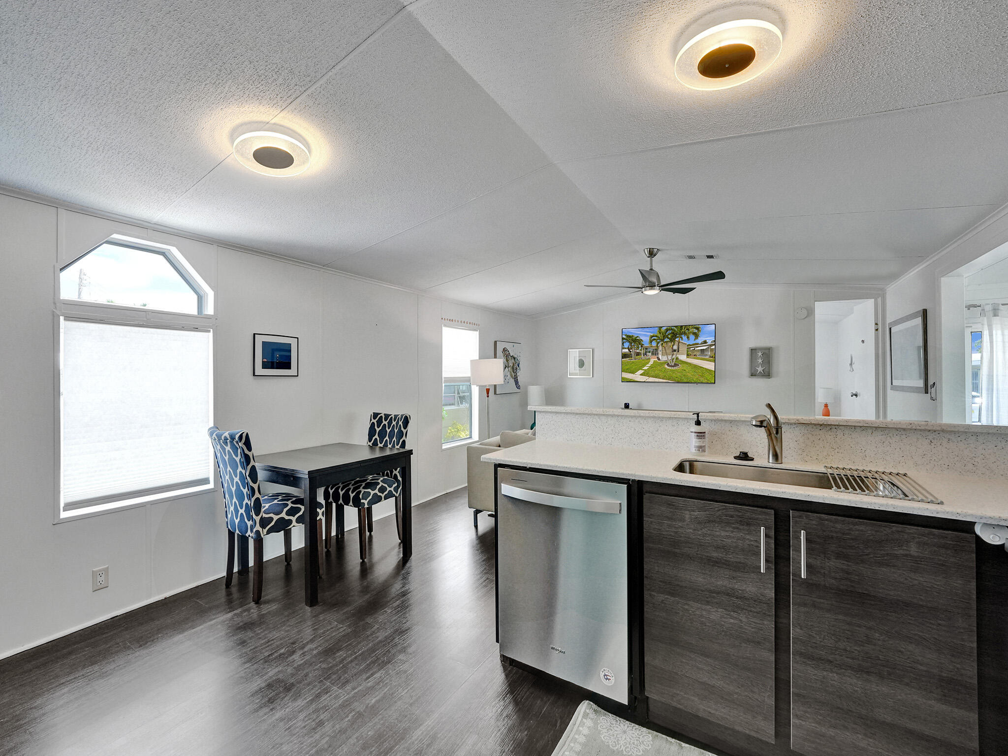 14609 Sunset Drive Delray Beach, FL 33445 - Photo 15 of 50 a kitchen with a sink a counter space and a dining table