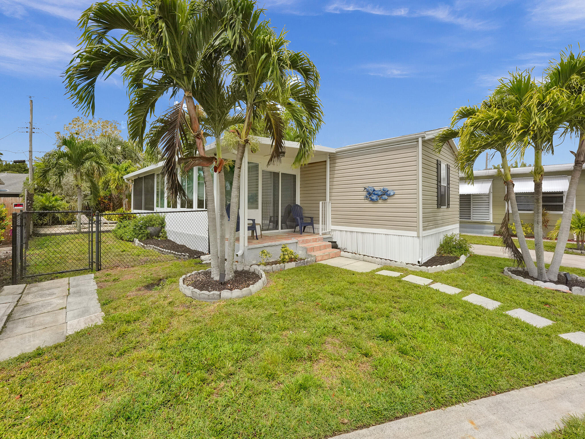 14609 Sunset Drive Delray Beach, FL 33445 - Photo 2 of 50 a front view of house with yard